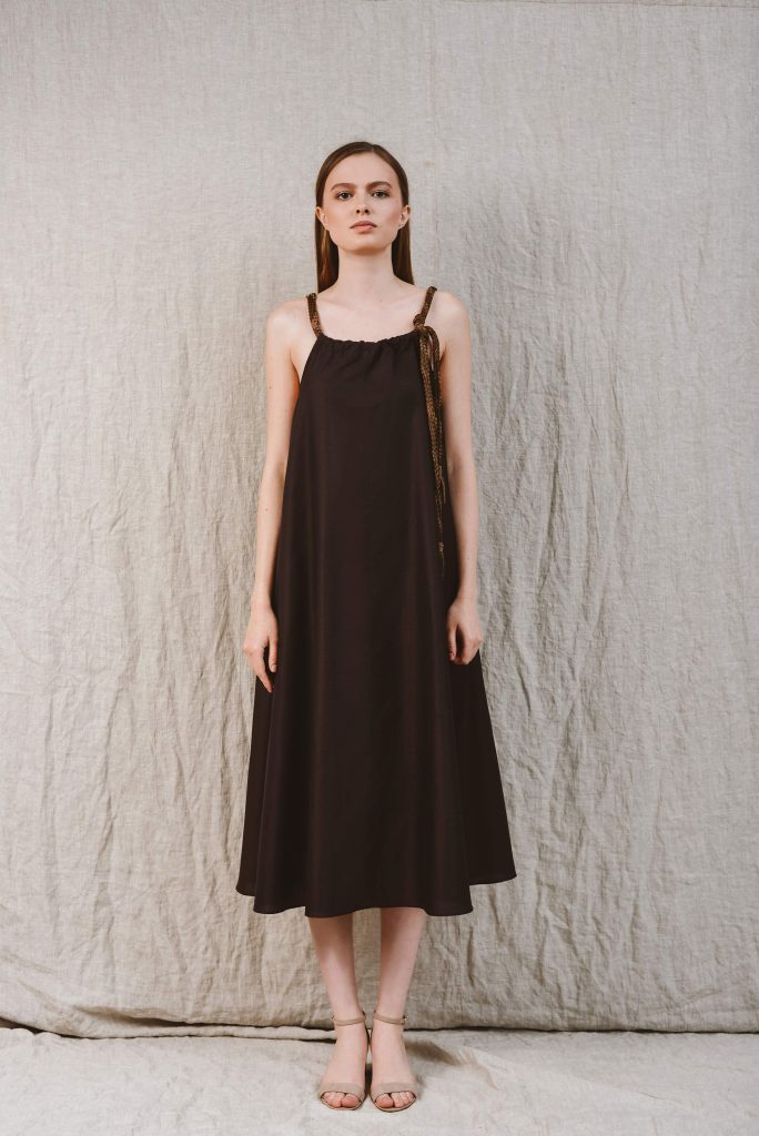a woman wearing a brown dress