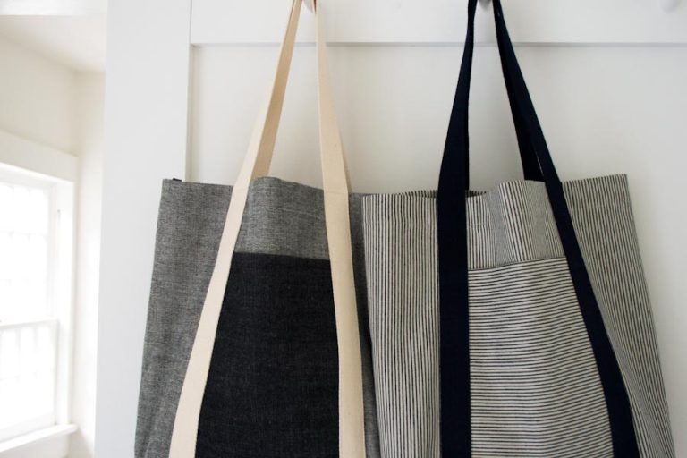 two tote bags hanging on hooks